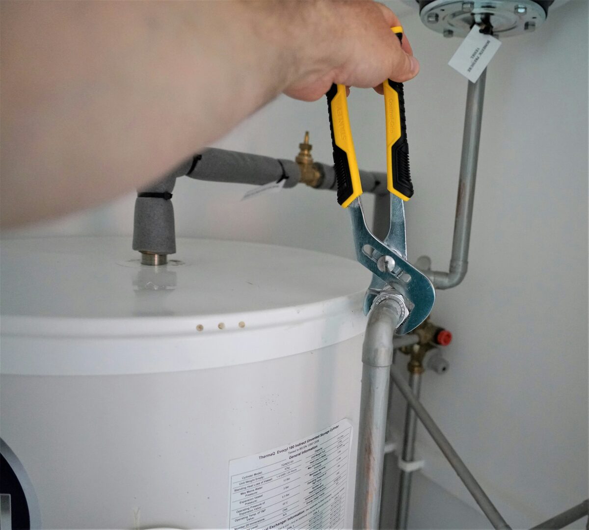 Carlos Rivera performing a water heater installation in a South Bronx apartment